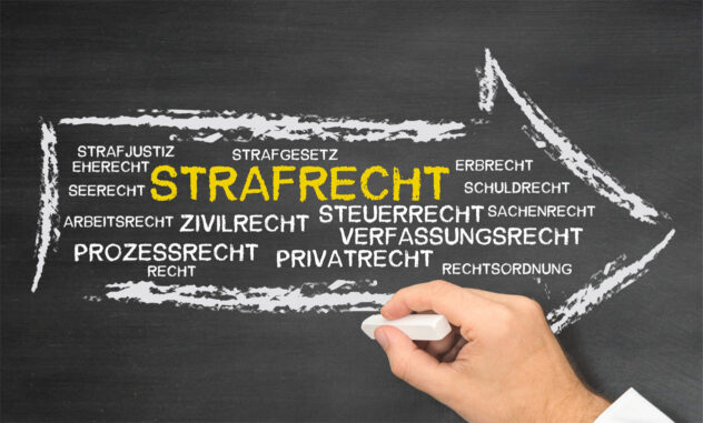 Schwarz-weiße Tafel mit gelb hervorgehobenem Wort »STRAFRECHT« und weiteren Rechtsgebieten in weißer Kreideschrift, daneben eine Hand mit weißer Kreide, die einen Pfeil zeichnet
